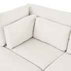 Divano sezionale a L beige con pouf, 4 posti a sedere